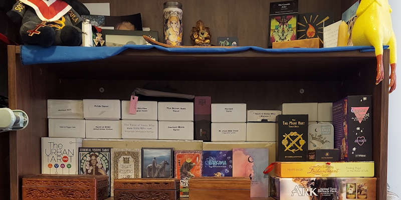 one shelf of tarot card decks,